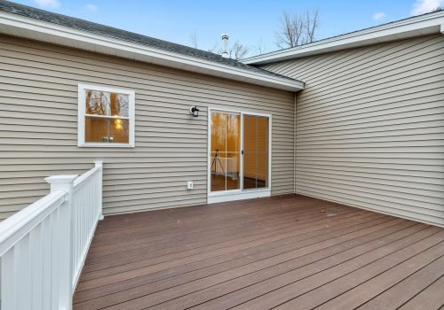 Contemporary and modern ranch-style house in the suburbs, and the decking boards of the porch